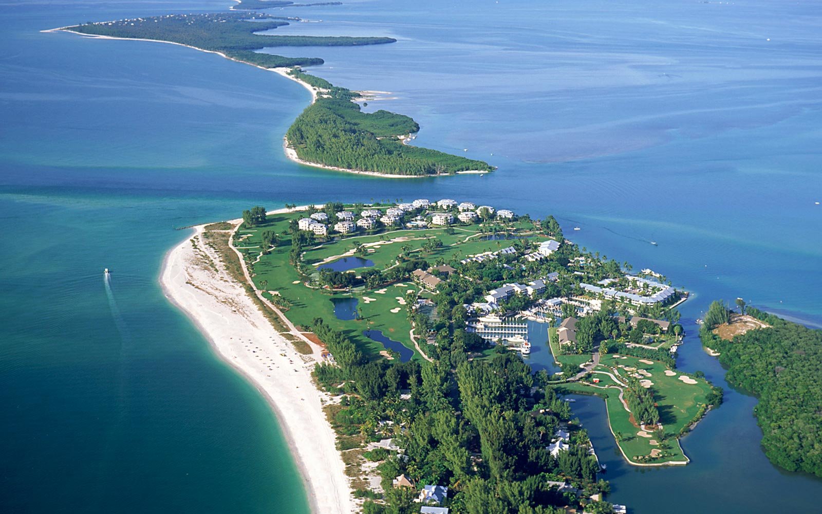 sanibel island in florida with blue water and white sand and residential homes